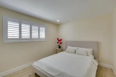 a white bedroom with a bed and a window at Centrally Located Retreat 5 Mi to San Diego Zoo! in San Diego