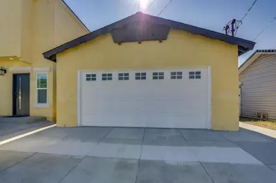 a yellow house with a white garage door at Centrally Located Retreat 5 Mi to San Diego Zoo! in San Diego