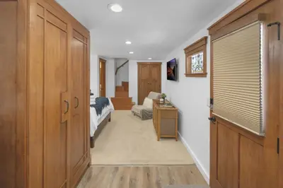 a hallway with a bedroom with a bed and a couch at Near All Things SD - Canyonview - Jacuzzi - EV Charge in San Diego