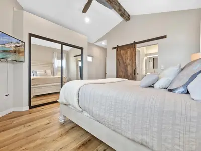 a bedroom with a large bed and a mirror at A4609b- Sunset Cliffs Dream Apartment in San Diego