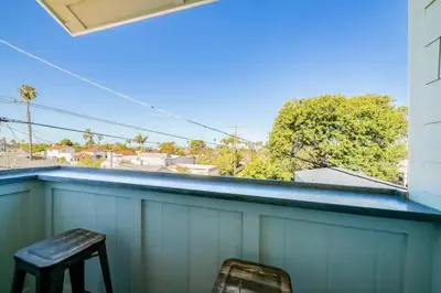 a balcony with two chairs and a blue roof at A4609b- Sunset Cliffs Dream Apartment in San Diego