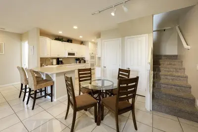 a kitchen and dining room with a table and chairs at Oceanside Beach Condos in Oceanside