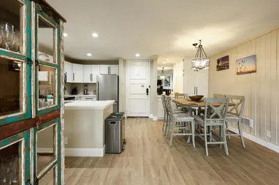 a kitchen and dining room with a table and chairs at Oceanside Beach Condos in Oceanside