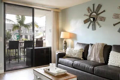 a living room with a couch and a tv at Oceanside Beach Condos in Oceanside