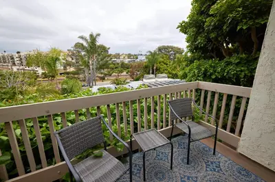 two chairs and a table on a balcony at Oceanside Beach Condos in Oceanside