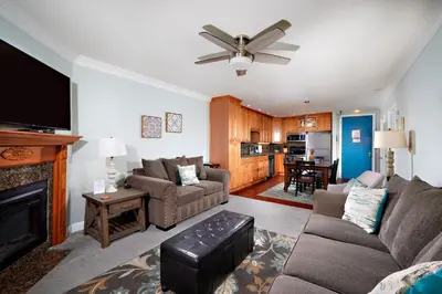 a living room with a couch and a fireplace at Oceanside Beach Condos in Oceanside