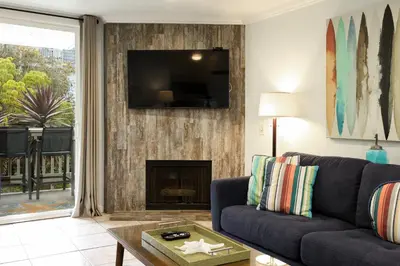 a living room with a couch and a fireplace at Oceanside Beach Condos in Oceanside