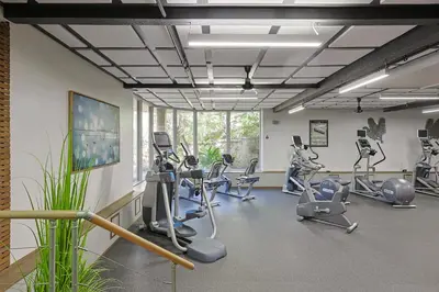 a gym with treadmills and elliptical machines at Oceanside Beach Condos in Oceanside