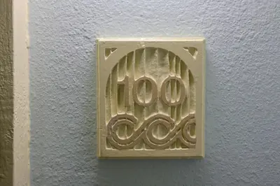 a metal object with the number on a wall at Oceanside Beach Condos in Oceanside