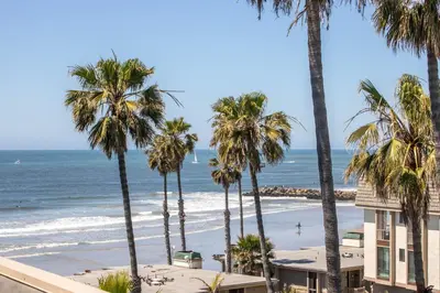 a view of the beach from the balcony of a condo at Oceanside Beach Condos in Oceanside