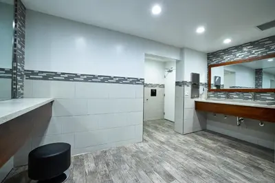 a bathroom with two sinks and a mirror at Oceanside Beach Condos in Oceanside