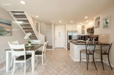 a kitchen and dining room with a table and chairs at Oceanside Beach Condos in Oceanside
