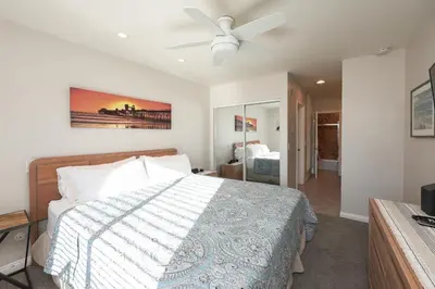 a bedroom with a bed and a ceiling fan at Oceanside Beach Condos in Oceanside