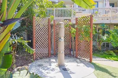 a pole in a garden with a fence at Oceanside Beach Condos in Oceanside