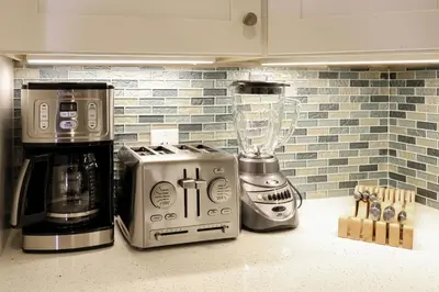 a kitchen counter with a coffee maker and a blender at Oceanside Beach Condos in Oceanside