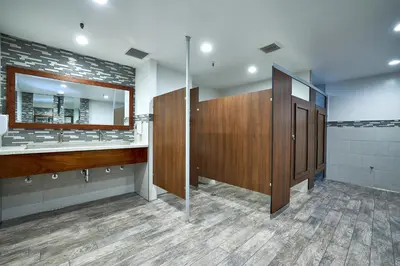 a bathroom with two sinks and a large mirror at Oceanside Beach Condos in Oceanside