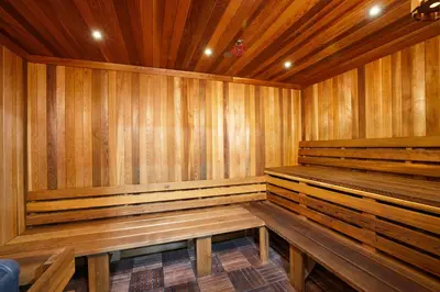 a wooden sauna with wooden benches in a room at Oceanside Beach Condos in Oceanside