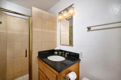 a bathroom with a sink and a shower at Oceanside Beach Condos in Oceanside