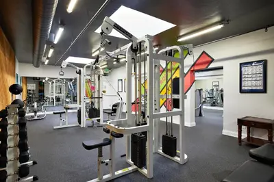 a gym with several tread machines in a room at Oceanside Beach Condos in Oceanside