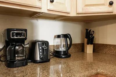 a kitchen counter with a coffee maker and a blender at Oceanside Beach Condos in Oceanside