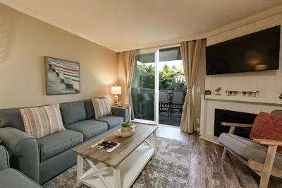 a living room with a couch and a table at Oceanside Beach Condos in Oceanside