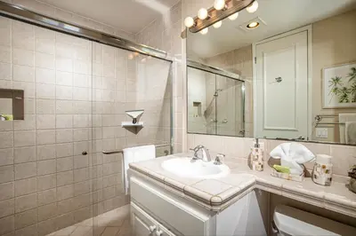 a bathroom with a sink and a mirror at Oceanside Beach Condos in Oceanside
