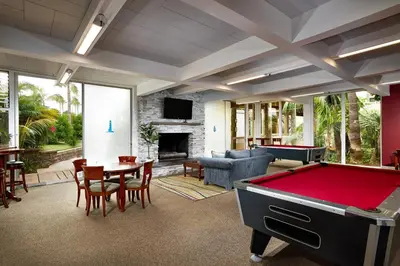 a pool table in a living room with a pool table at Oceanside Beach Condos in Oceanside