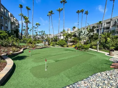 a miniature golf course with palm trees and condos at Oceanside Beach Condos in Oceanside