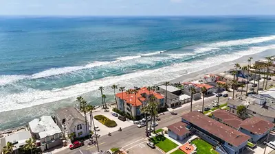 an aerial view of a beach with buildings and the ocean at Beachfront Retreat in Oceanside