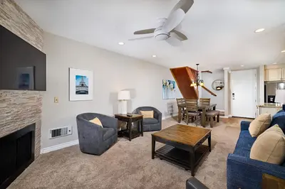 a living room with a couch and chairs and a fireplace at Oceanside Beach Condos in Oceanside