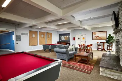 a billiard room with a pool table and a living room at Oceanside Beach Condos in Oceanside