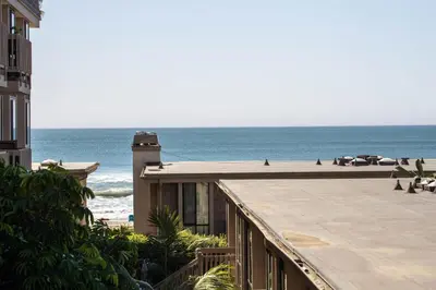 a view of the beach from the balcony of a building at Oceanside Beach Condos in Oceanside