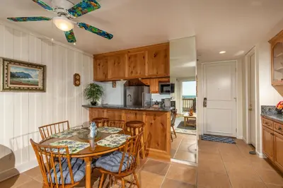 a kitchen with a table and chairs and a dining room at Oceanside Beach Condos in Oceanside