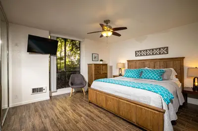 a bedroom with a bed and a ceiling fan at Oceanside Beach Condos in Oceanside