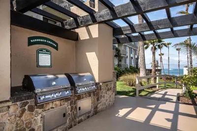 a outdoor grill with a view of the ocean at Oceanside Beach Condos in Oceanside