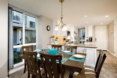 a kitchen and dining room with a wooden table and chairs at Oceanside Beach Condos in Oceanside