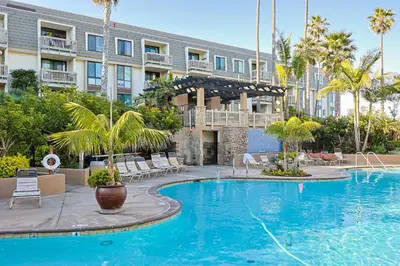 a swimming pool in front of a building at Oceanside Beach Condos in Oceanside