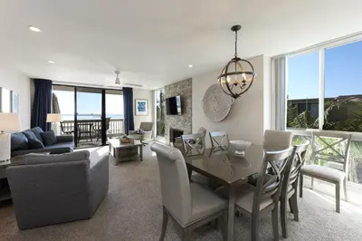a living room with a table and a dining room at Oceanside Beach Condos in Oceanside