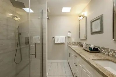 a bathroom with a shower and a sink at Oceanside Beach Condos in Oceanside