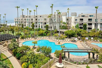 an aerial view of a resort with a swimming pool at Oceanside Beach Condos in Oceanside