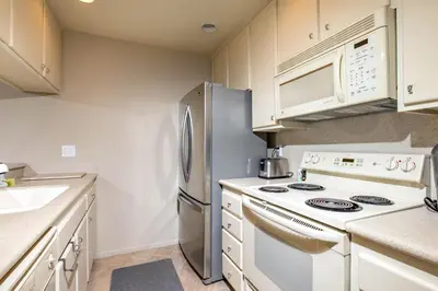 a kitchen with a stove and a refrigerator at Oceanside Beach Condos in Oceanside