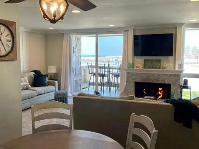 a living room with a fireplace and a tv at Oceanside Beach Condos in Oceanside