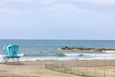 a lifeguard tower on a beach with the ocean at Oceanside Beach Condos in Oceanside