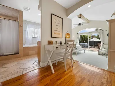 a home office with a desk and a dining room at Luxury beach home one block from ocean with spa, WiFi, & gorgeous outdoor space in San Diego