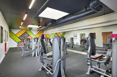 a gym with rows of tread machines in a room at Oceanside Beach Condos in Oceanside