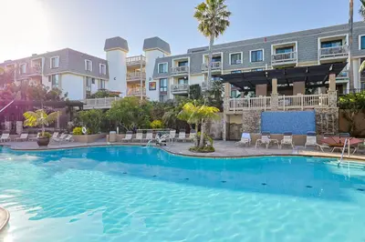 a large swimming pool in front of a building at Oceanside Beach Condos in Oceanside