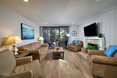 a large living room with couches and a tv at Oceanside Beach Condos in Oceanside