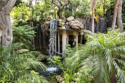 a waterfall in the middle of a garden at Oceanside Beach Condos in Oceanside