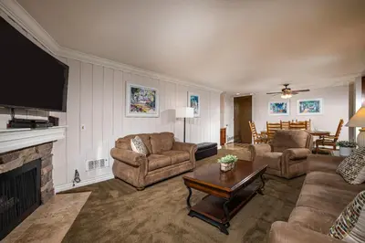 a living room with two couches and a fireplace at Oceanside Beach Condos in Oceanside