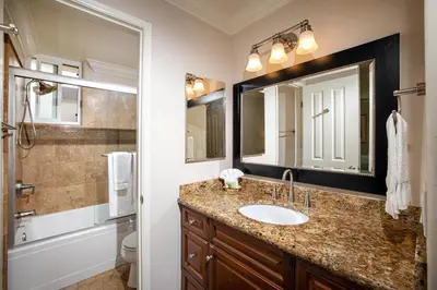 a bathroom with a sink and a mirror at Oceanside Beach Condos in Oceanside